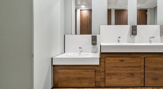 Venesta toilets and washrooms sitting alongside a computer screen showing Fabrick's PPC results